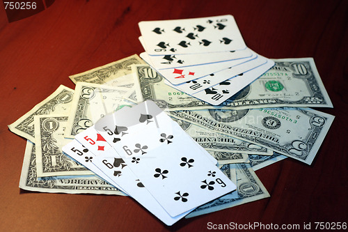 Image of playing combination in poker and money for rate on table