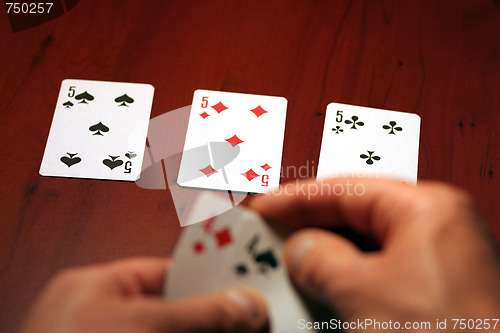 Image of hand of the person with card for poker and rate in dollars