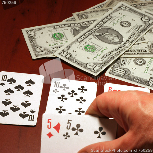 Image of hand of the person with card for poker and rate in dollars