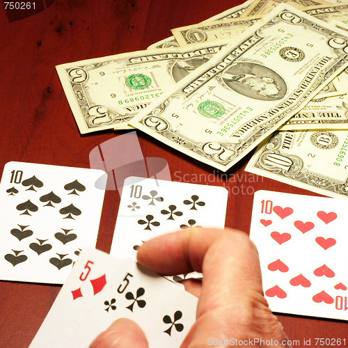 Image of hand of the person with card for poker and rate in dollars