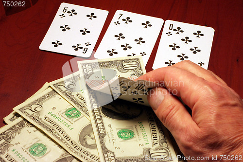 Image of hand of the person with card for poker and rate in dollars