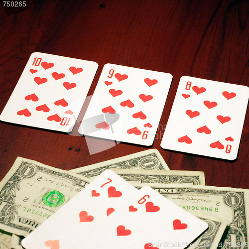 Image of playing combination in poker and money for rate on table