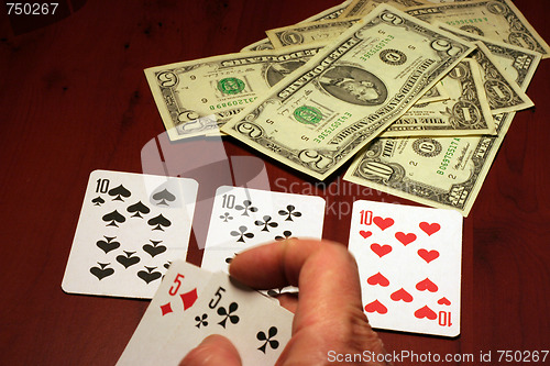 Image of hand of the person with card for poker and rate in dollars