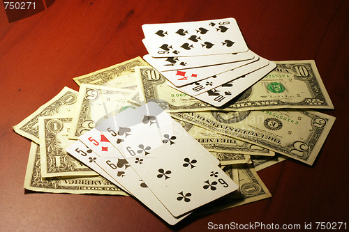 Image of playing combination in poker and money for rate on table