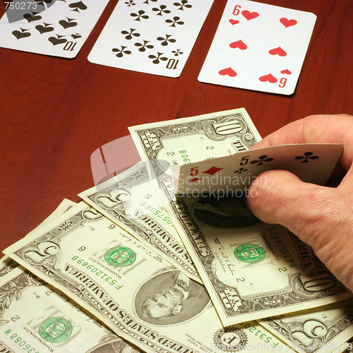 Image of hand of the person with card for poker and rate in dollars