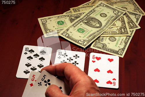 Image of hand of the person with card for poker and rate in dollars