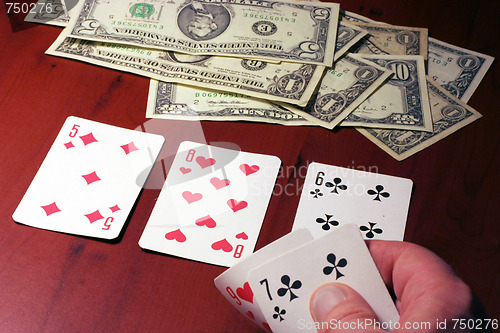 Image of hand of the person with card for poker and rate in dollars