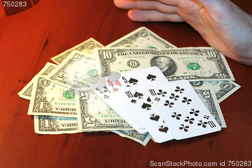 Image of hand of the person with card for poker and rate in dollars