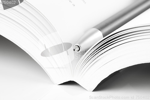 Image of open book and pen