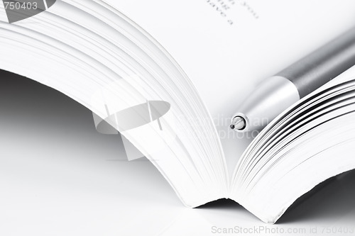 Image of open book and pen