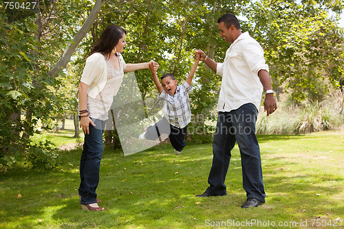 Image of Young Hispanic Family Having Fun in the Park