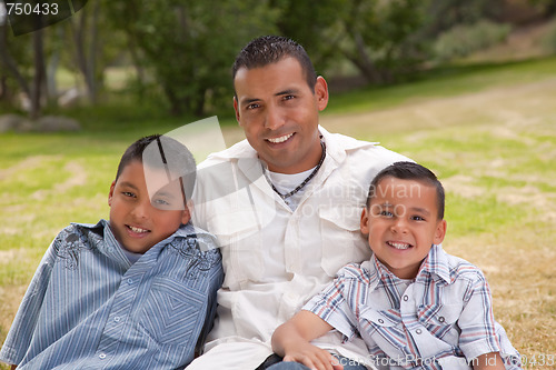 Image of Hispanic Father and Sons in the Park