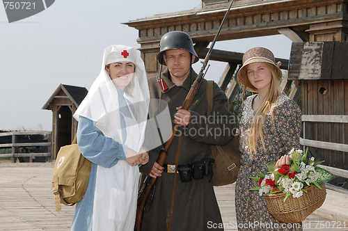 Image of Retro styled picture with two womens and soldier