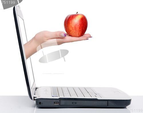 Image of hand with apple and laptop