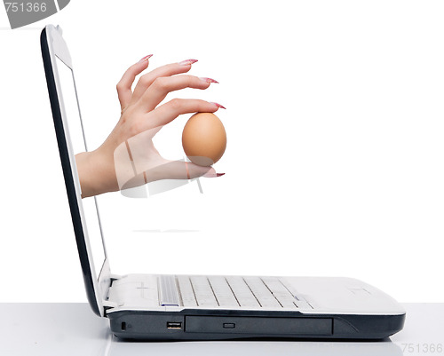 Image of hand with egg and laptop
