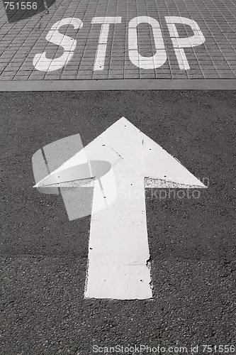 Image of Stop and Arrow Painted on Road