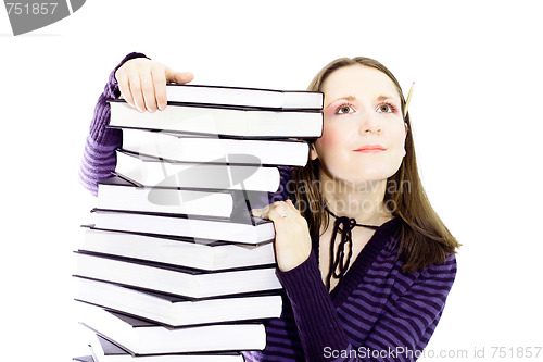 Image of woman preperaing for exam with toons of books