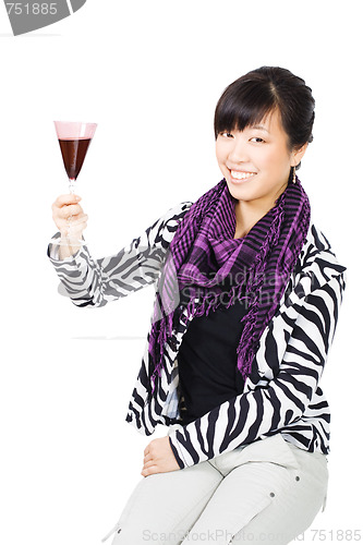 Image of Asian woman drinking wine from purple glass