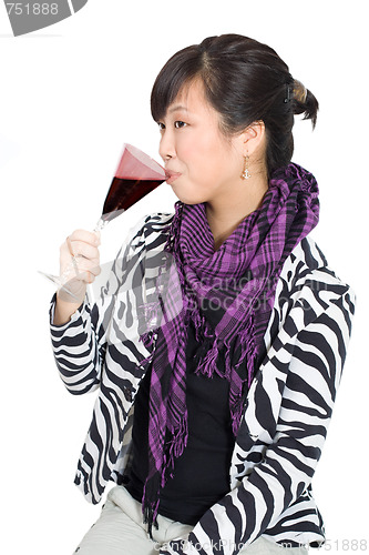 Image of Asian woman drinking wine from purple glass