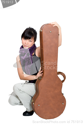 Image of Asian woman with guitar case