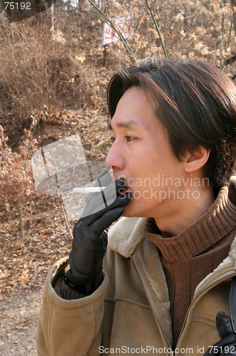 Image of Asian man smoking