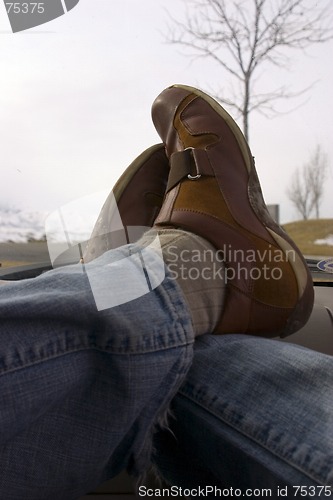 Image of Feet crossed over on the Dashboard Relaxing