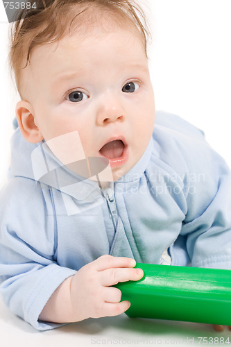 Image of Baby playing with green plastic block