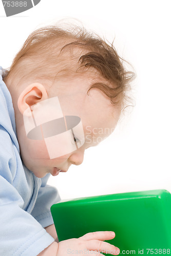 Image of Baby playing with green plastic block