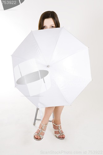 Image of woman hiding behind umbrella