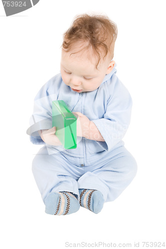 Image of Baby playing with green plastic block