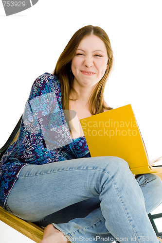 Image of Woman sitting with yellow book