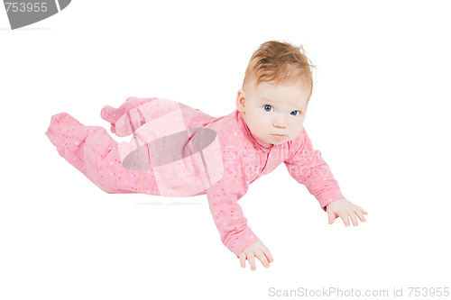 Image of little boy in ping pyjamas creeping on the floor