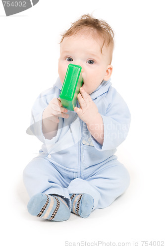 Image of Baby playing with green plastic block