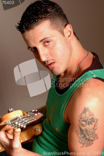 Image of bass player with tattoo 2513