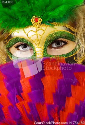 Image of face of woman in mask with fan