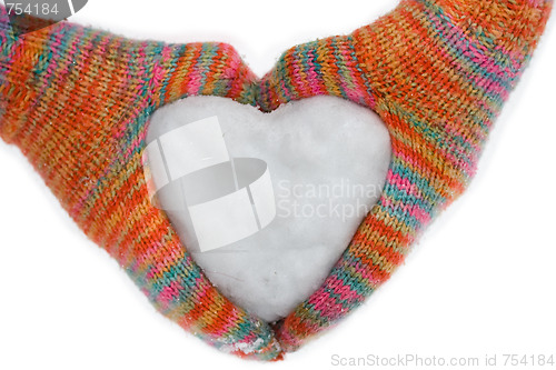 Image of heart of snow in gloves