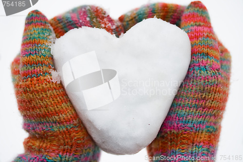 Image of heart of snow in gloves