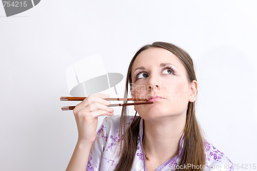 Image of Woman with chopsticks for sushi