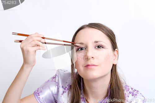 Image of Woman with chopsticks for sushi