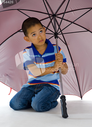 Image of cute boy under huge umbrella