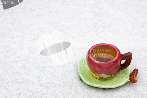 Image of A cup of tea is on the snow