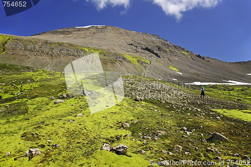 Image of Hiker climbing an unspoiled mountain side