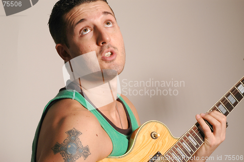 Image of guitarist hitting the high note
