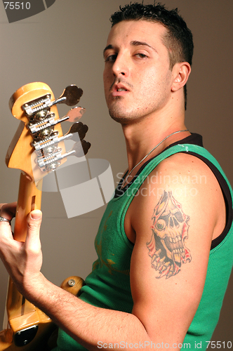 Image of bass player with tattoo