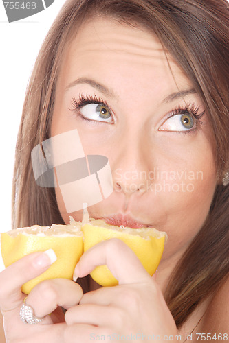 Image of happy model eating a Lemon