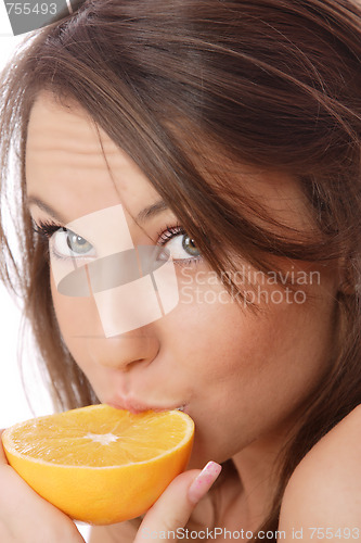 Image of happy model eating an orange