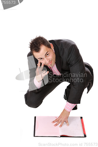 Image of Confident businessman with notebook