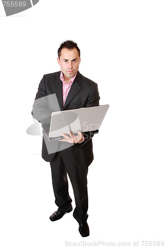 Image of Happy businessman holding laptop computer