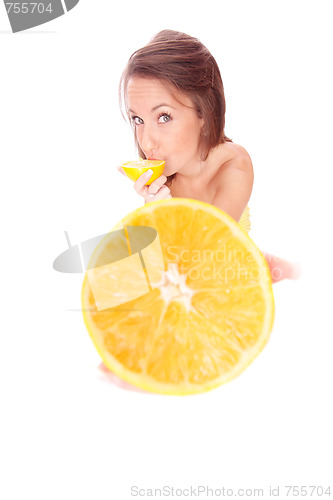Image of happy model eating an orange