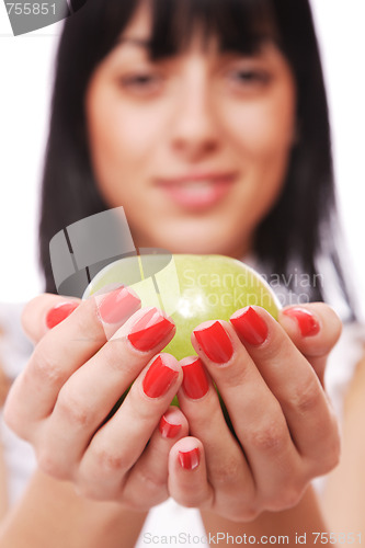 Image of A pretty young woman holding an apple 